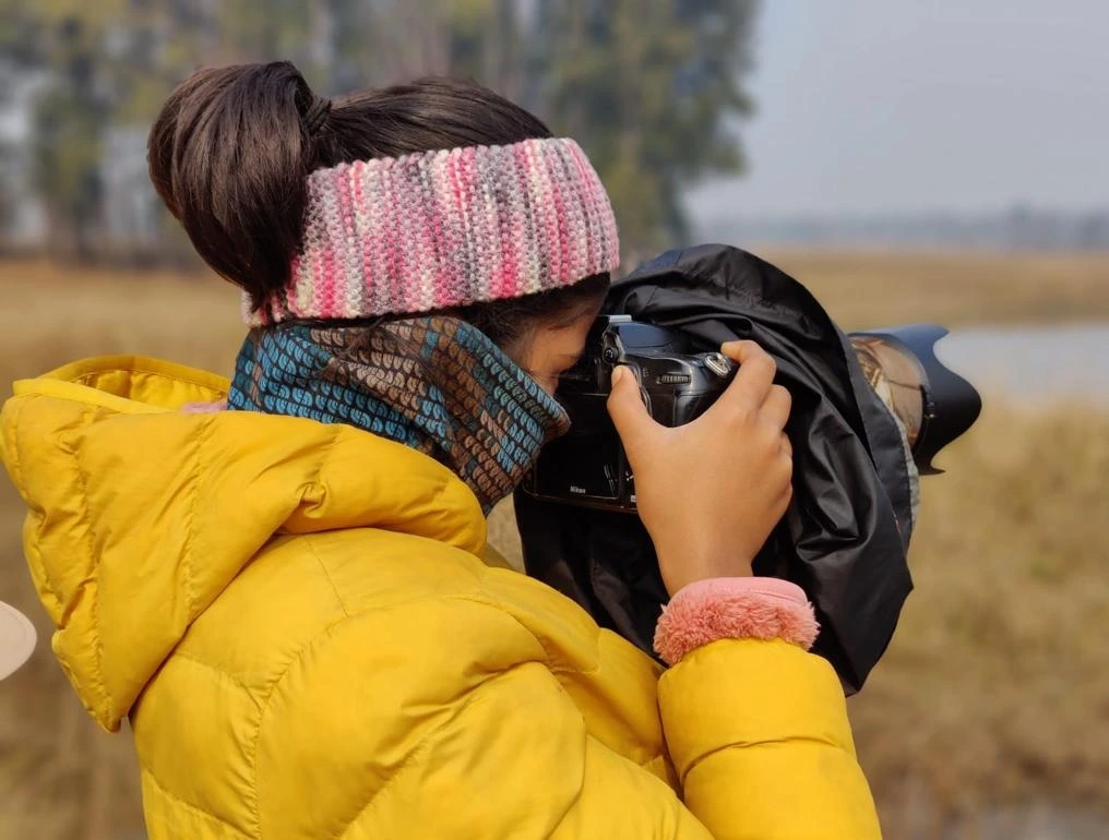 Photographer with a large camera lens
